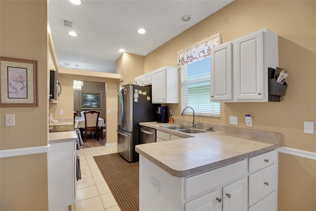 32915 Crooked Oaks Ln, Leesburg, FL 34748 - kitchen featuring appliances with stainless steel finishes, a sink, visible vents, and white cabinetry