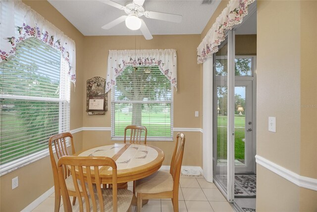 32915 Crooked Oaks Ln, Leesburg, FL 34748 - dining room with light tile patterned floors, ceiling fan, plenty of natural light, and baseboards
