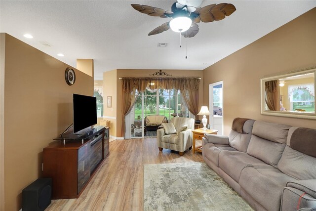 32915 Crooked Oaks Ln, Leesburg, FL 34748 - living room featuring light wood finished floors, visible vents, and a ceiling fan