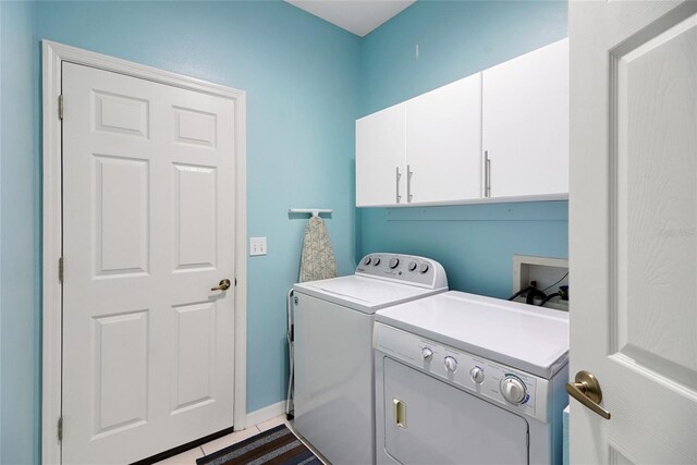 32915 Crooked Oaks Ln, Leesburg, FL 34748 - washroom featuring tile patterned floors, cabinet space, and washer and dryer