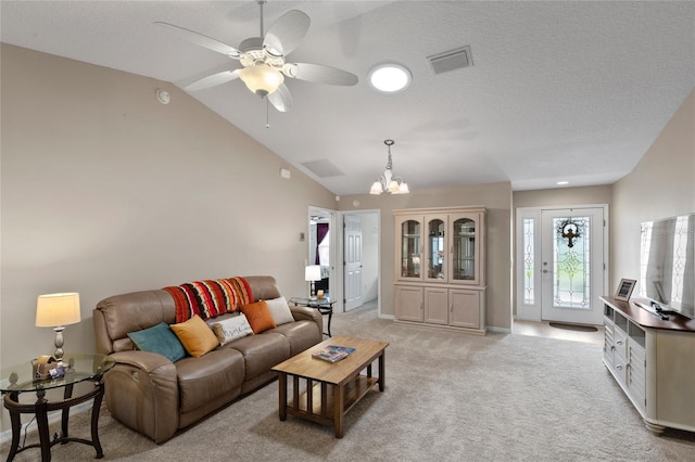 living room featuring lofted ceiling, ceiling fan with notable chandelier, visible vents, and light colored carpet