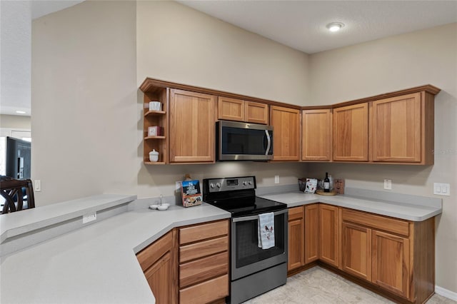 kitchen featuring stainless steel appliances, open shelves, light countertops, and brown cabinets