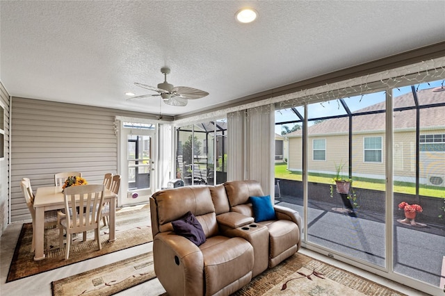 sunroom featuring a healthy amount of sunlight and ceiling fan