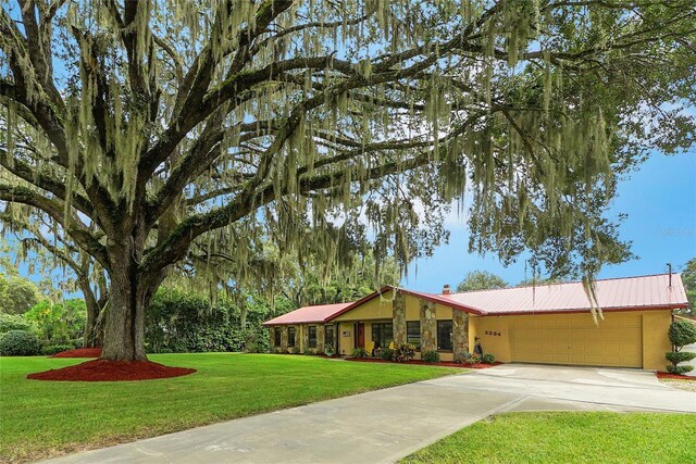 single story home with a front yard and a garage