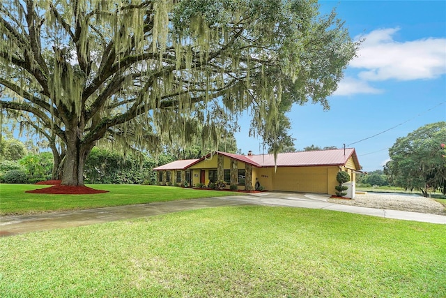 view of front of house featuring a garage and a front lawn