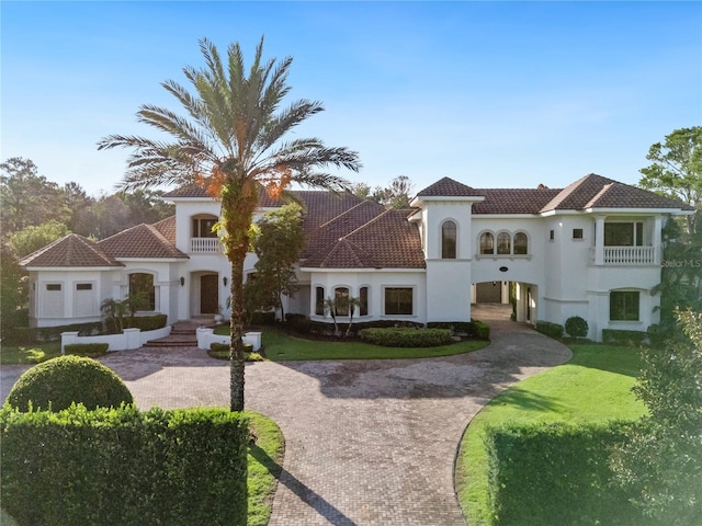 mediterranean / spanish house featuring a front yard