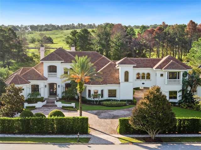 mediterranean / spanish-style home featuring a balcony