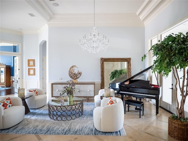 sitting room with ornamental molding, a high ceiling, and an inviting chandelier