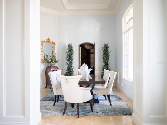 tiled dining space featuring ornamental molding