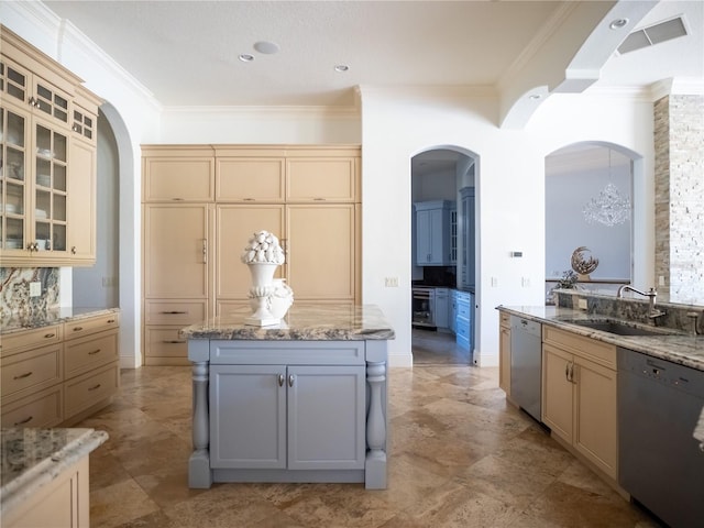 kitchen with crown molding, sink, and stainless steel dishwasher