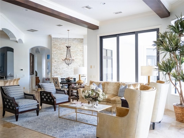 living room featuring a chandelier, beamed ceiling, a wealth of natural light, and crown molding