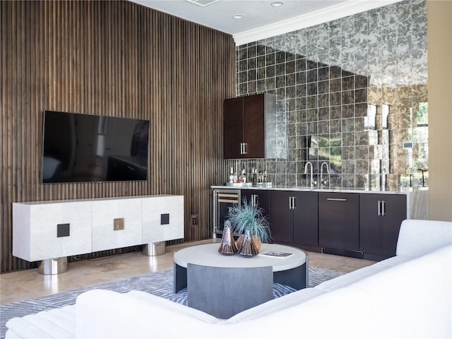 interior space featuring sink, crown molding, and beverage cooler