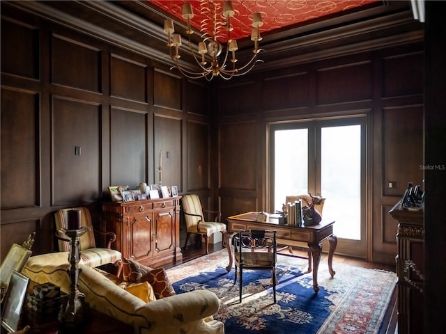 office space featuring hardwood / wood-style flooring, wood walls, ornamental molding, and an inviting chandelier