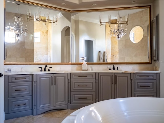 bathroom featuring vanity, crown molding, and a tub