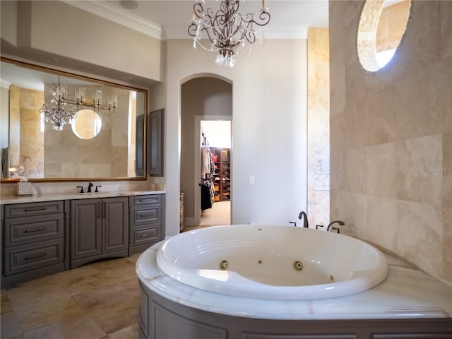 bathroom with a chandelier, vanity, a tub, and crown molding