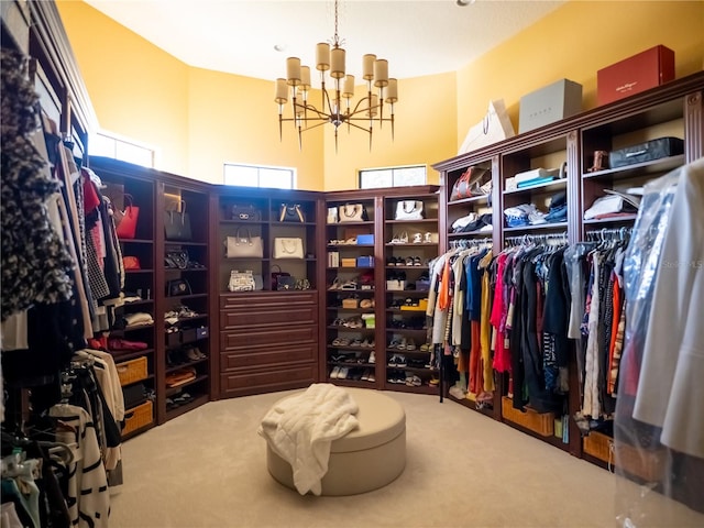 spacious closet featuring carpet flooring and a notable chandelier