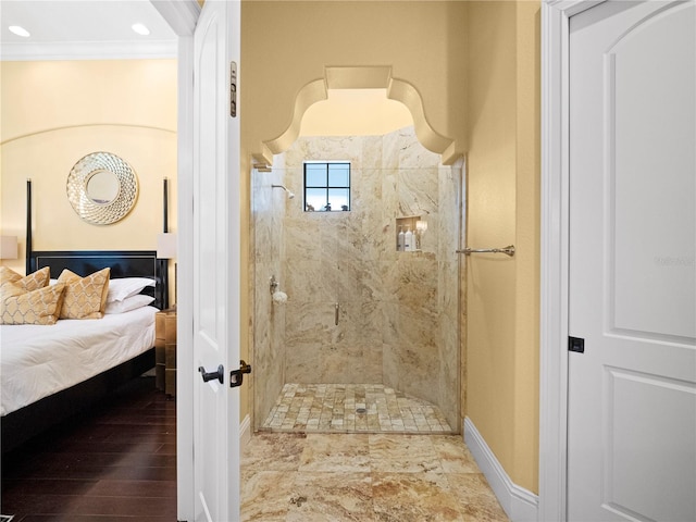 bathroom featuring crown molding, wood-type flooring, and tiled shower