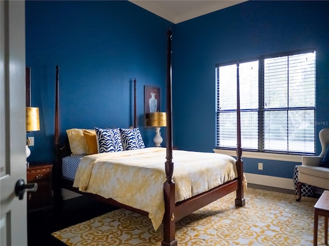 bedroom featuring crown molding and multiple windows