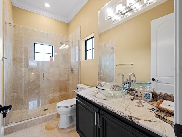 bathroom featuring vanity, toilet, crown molding, and a wealth of natural light