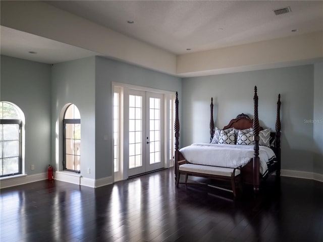 bedroom featuring dark hardwood / wood-style floors, access to outside, and french doors