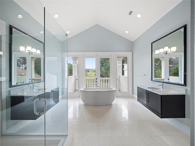 bathroom with vanity, separate shower and tub, lofted ceiling, and french doors