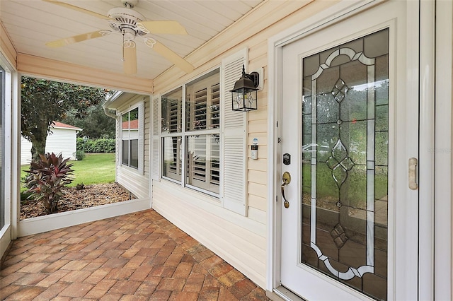 entrance to property featuring ceiling fan