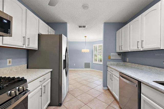 kitchen featuring appliances with stainless steel finishes, white cabinetry, and light tile patterned floors