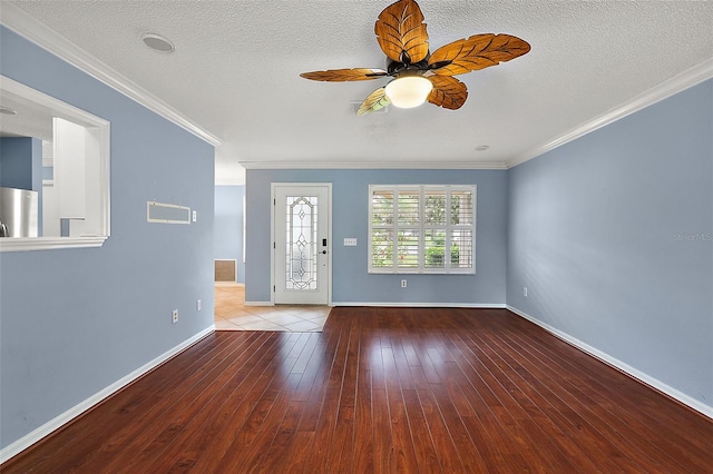 foyer featuring a textured ceiling, crown molding, and hardwood / wood-style flooring