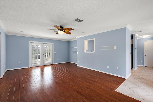 unfurnished room featuring a textured ceiling, french doors, crown molding, ceiling fan, and light wood-type flooring