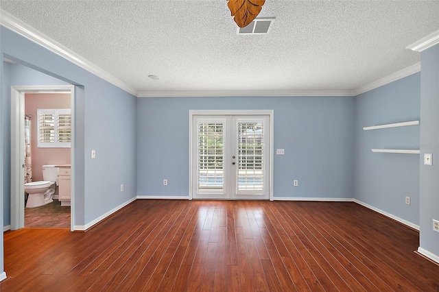 spare room with a textured ceiling, ornamental molding, wood-type flooring, and french doors