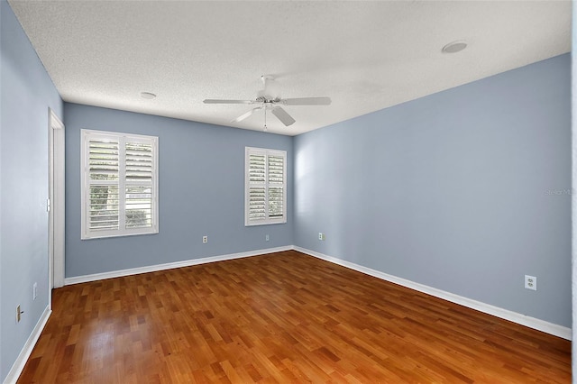 spare room with a textured ceiling, hardwood / wood-style flooring, and ceiling fan