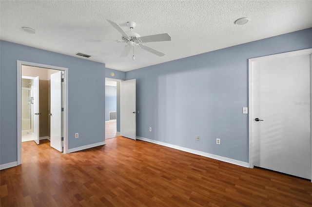 unfurnished bedroom with a textured ceiling, hardwood / wood-style floors, and ceiling fan