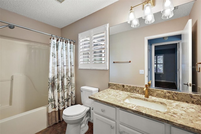 full bathroom with a textured ceiling, vanity, toilet, tile patterned floors, and shower / bath combo with shower curtain