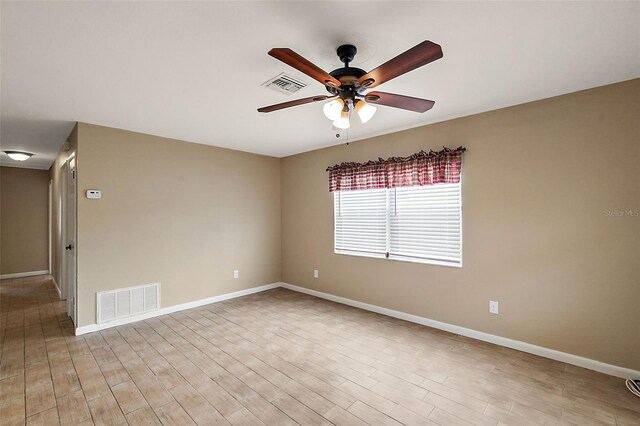 unfurnished room with ceiling fan and light wood-type flooring