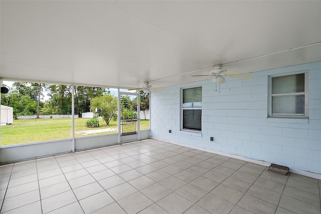 unfurnished sunroom with ceiling fan