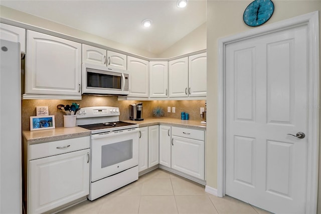 kitchen with white cabinets, white appliances, lofted ceiling, and backsplash