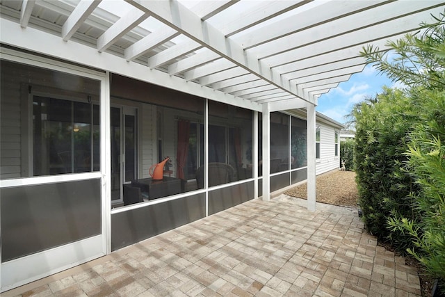 view of patio with a pergola and a sunroom