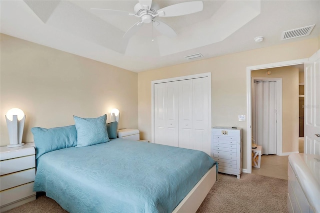 carpeted bedroom featuring a closet and ceiling fan