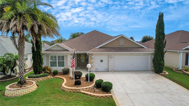 single story home featuring a garage and a front yard