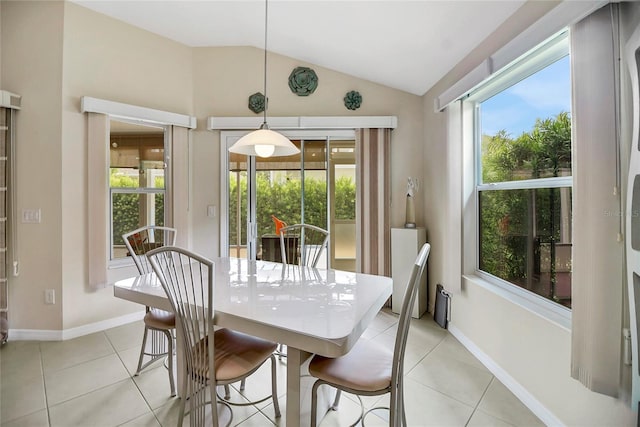 tiled dining area with a wealth of natural light and vaulted ceiling