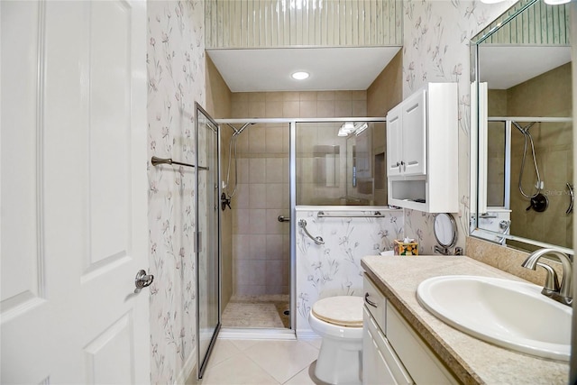 bathroom featuring tile patterned floors, toilet, vanity, and walk in shower