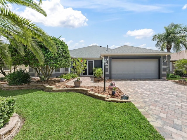 single story home featuring a garage and a front lawn