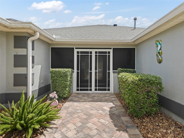 view of exterior entry featuring a patio area