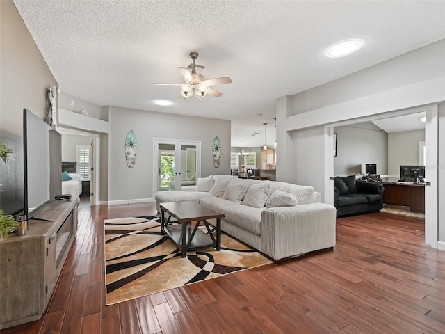 living room with french doors, wood-type flooring, a textured ceiling, and ceiling fan