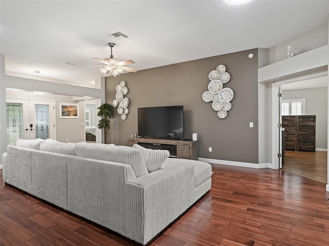 living room featuring french doors, ceiling fan, and dark hardwood / wood-style floors