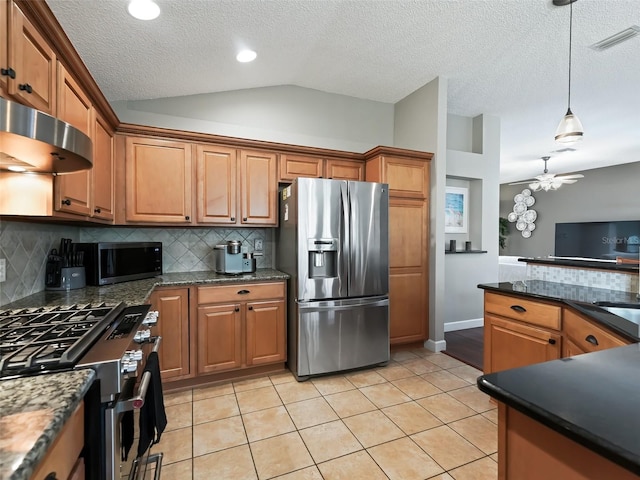 kitchen with decorative light fixtures, backsplash, appliances with stainless steel finishes, lofted ceiling, and ceiling fan