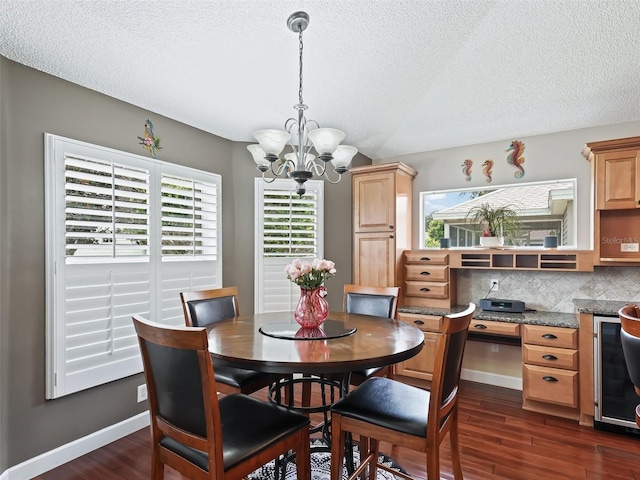 dining space featuring dark hardwood / wood-style flooring, wine cooler, a notable chandelier, and a textured ceiling