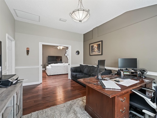 office space with a textured ceiling, lofted ceiling, and dark hardwood / wood-style floors