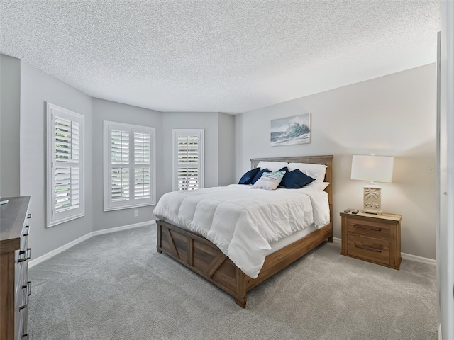 bedroom featuring carpet and a textured ceiling