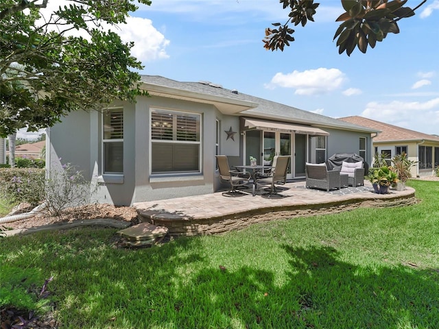 rear view of house featuring a yard and a patio area